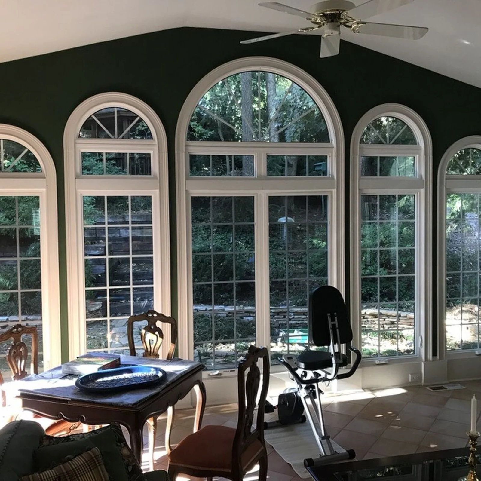 Living room with tall arched replacement windows letting in daylight